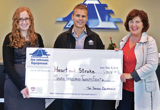 representatives from joe johnson equipment presenting a check to the heart and stroke foundation